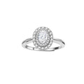 Sterling silver ring with oval moissanite center stone surrounded by double halo of sparkling stones on neutral background.