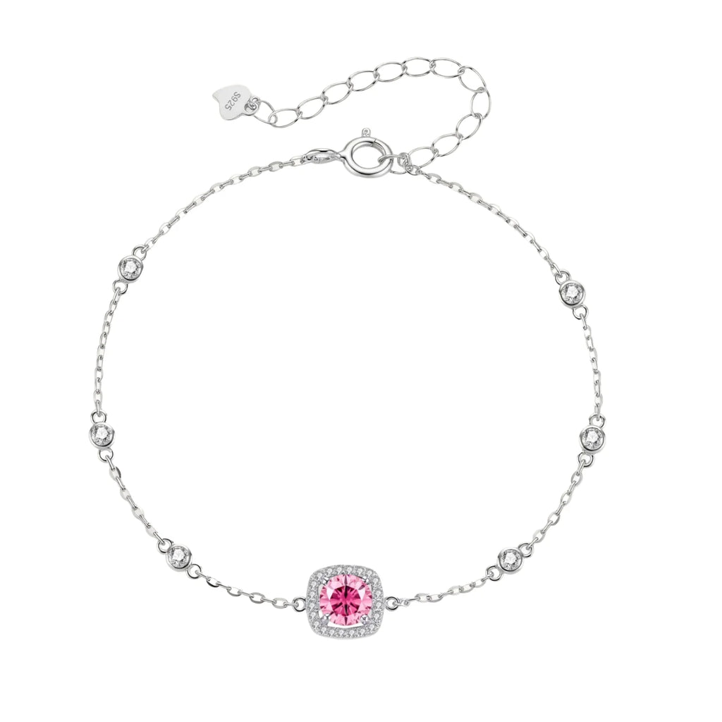 Sterling silver jewelry set featuring pink moissanite stones in halo settings on white background.