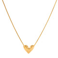 Dainty 18K gold-plated sterling silver necklace with small heart pendant on delicate chain against cream background.